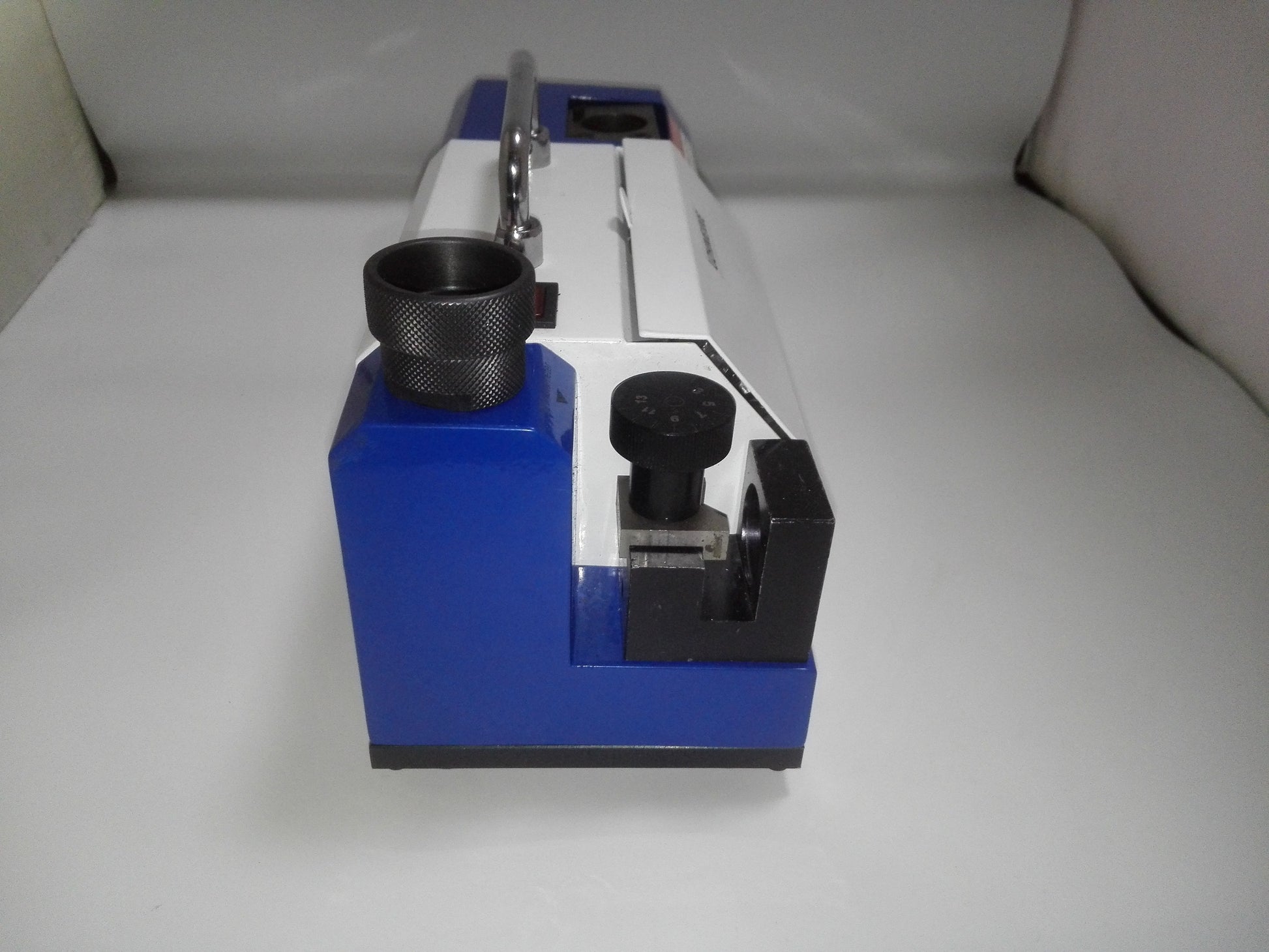 Rear view of drill bit grinder with AC 220V power inlet label