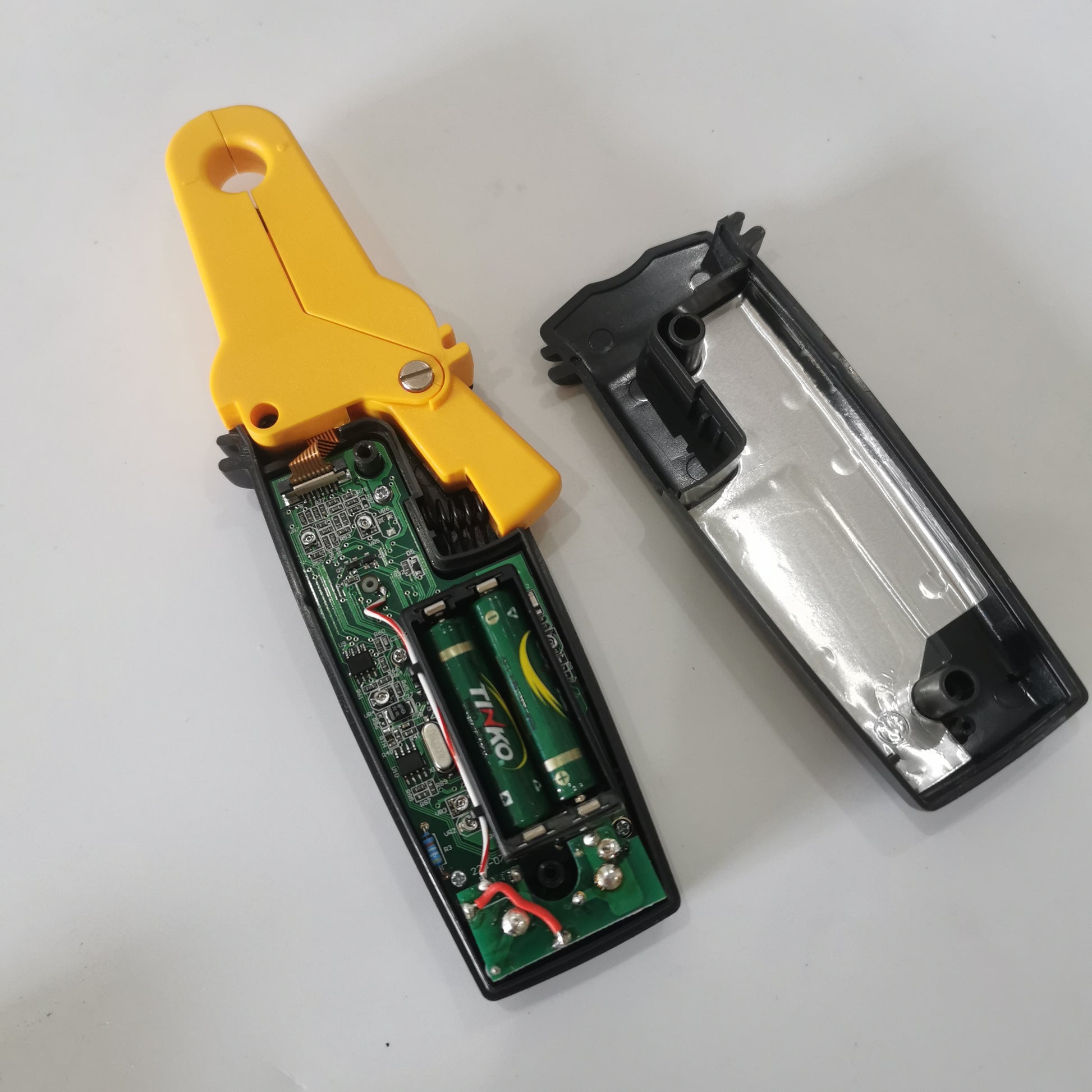 Inside view of CENTER 223 clamp meter showing AAA batteries and circuit board