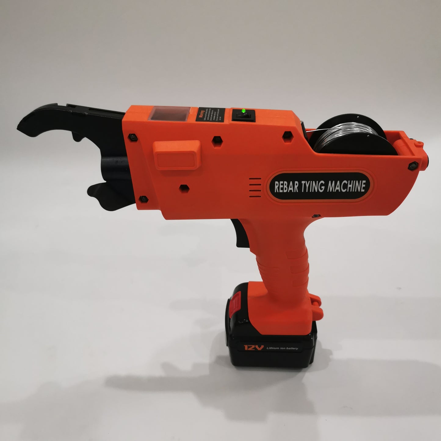 Handheld electric rebar tying machine with rear wire reel and 12V battery