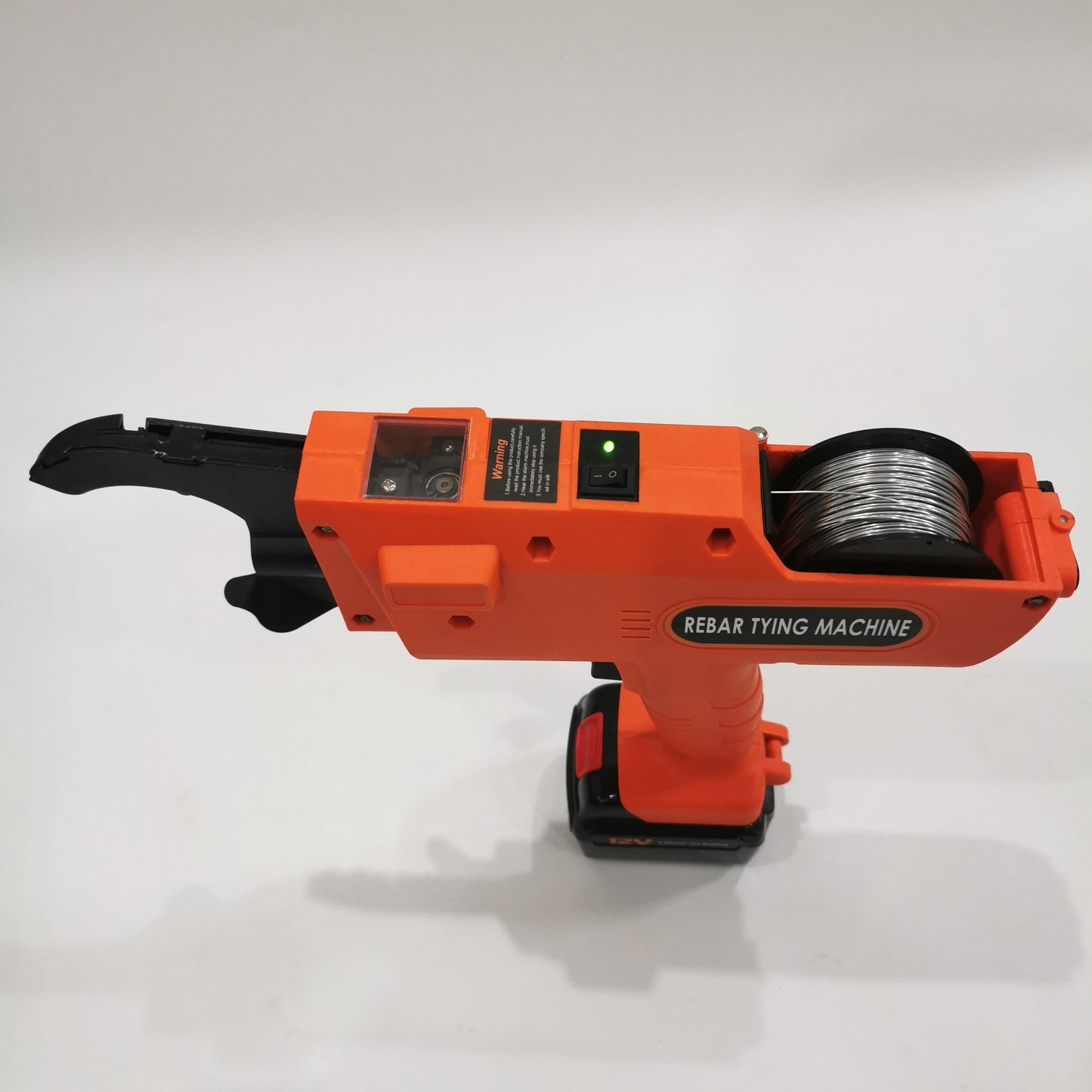 Automatic rebar tier side view showing wire reel feed and power switch