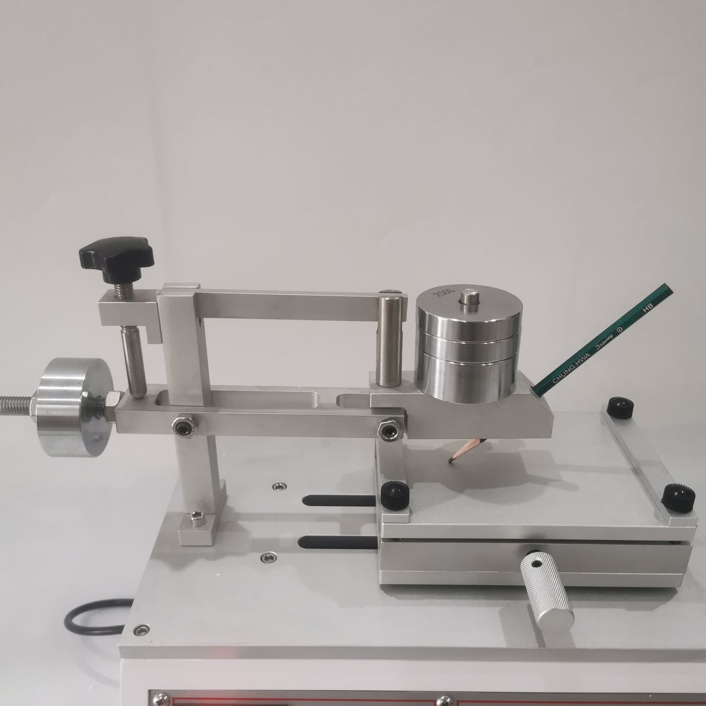 Pencil hardness tester arm with adjustable weights and sample platform