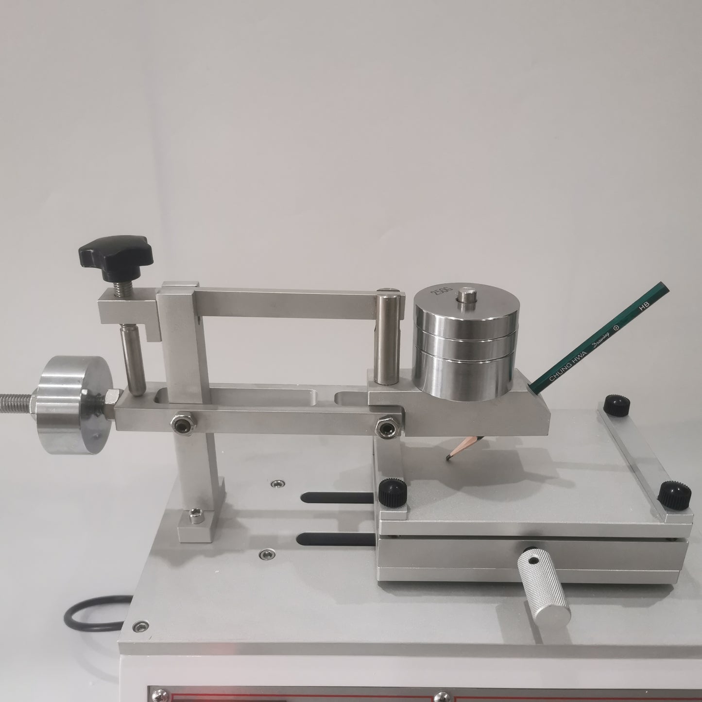 Pencil hardness tester arm with adjustable weights and sample platform