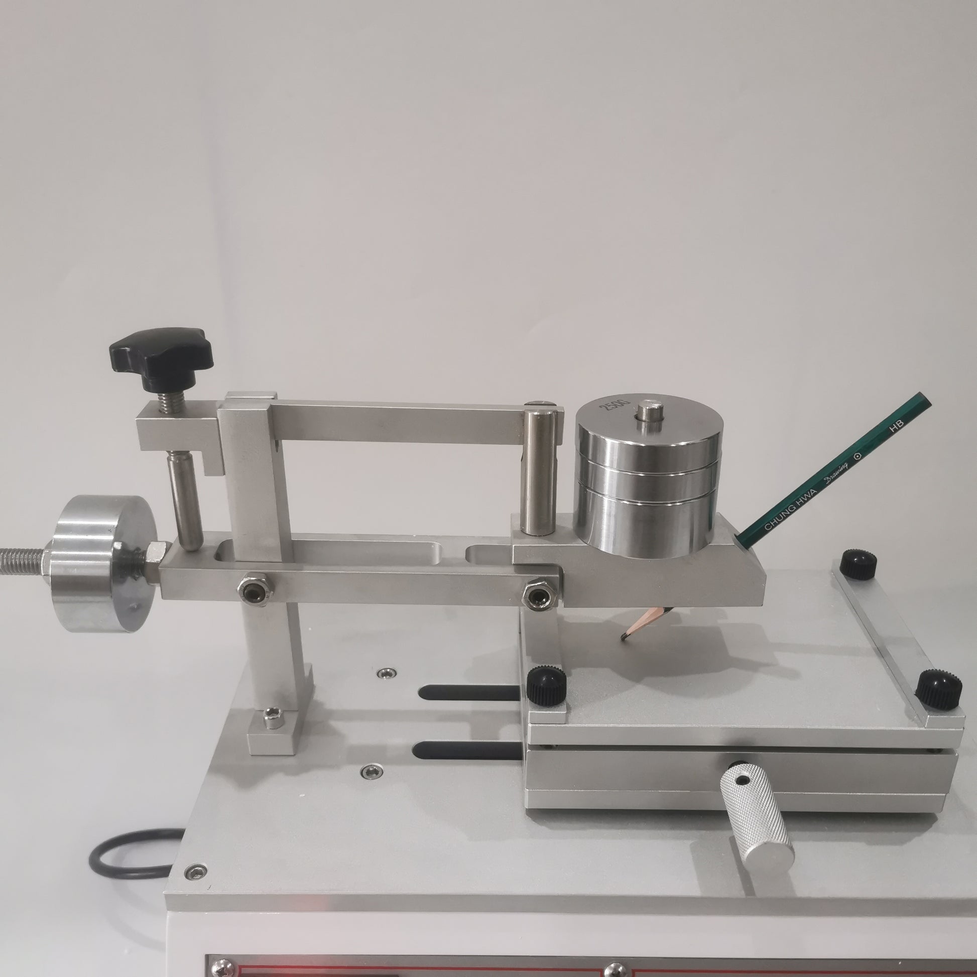 Pencil hardness tester arm with adjustable weights and sample platform