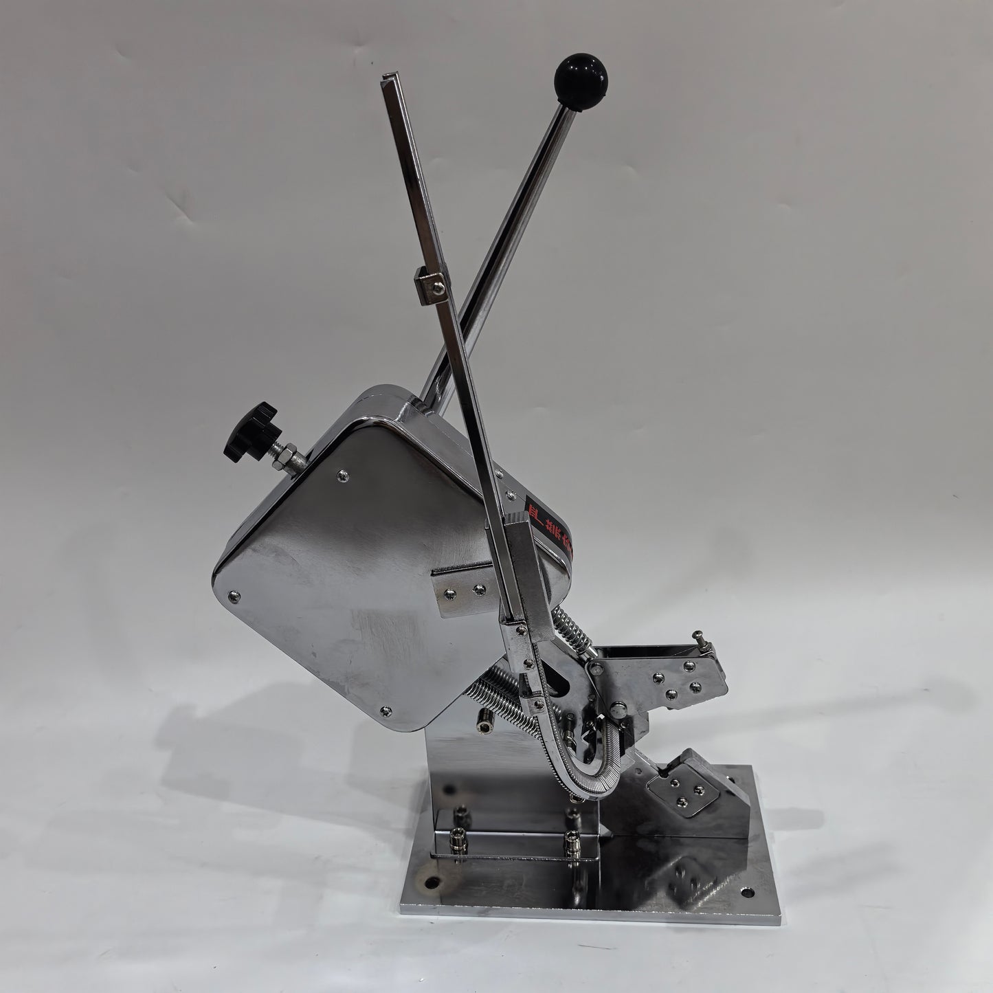 Side view of manual U-shape sausage clipping machine on desktop base