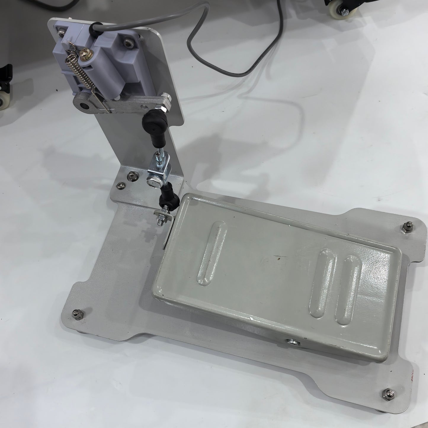 Leather skiving machine foot pedal assembly and base plate