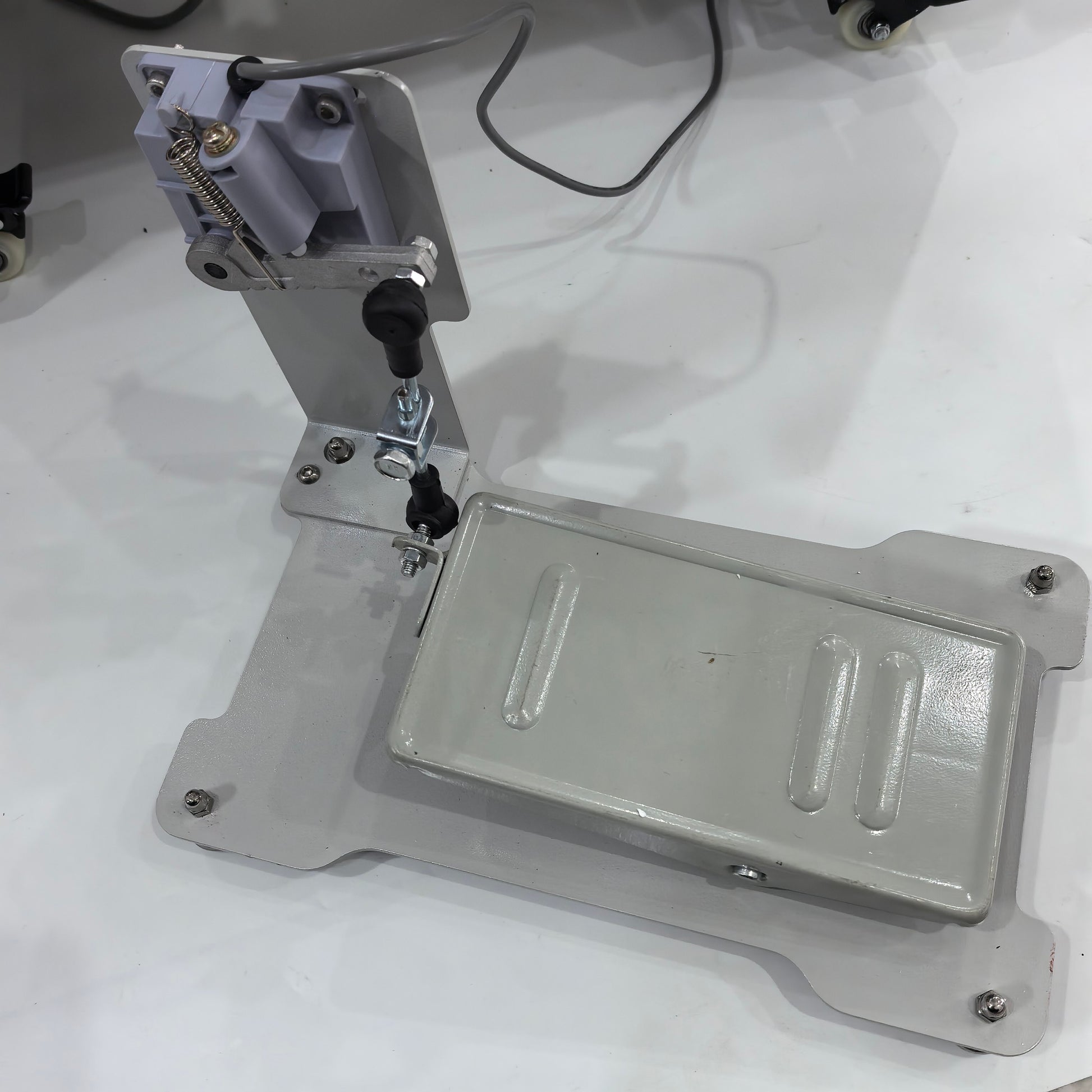 Leather skiving machine foot pedal assembly and base plate
