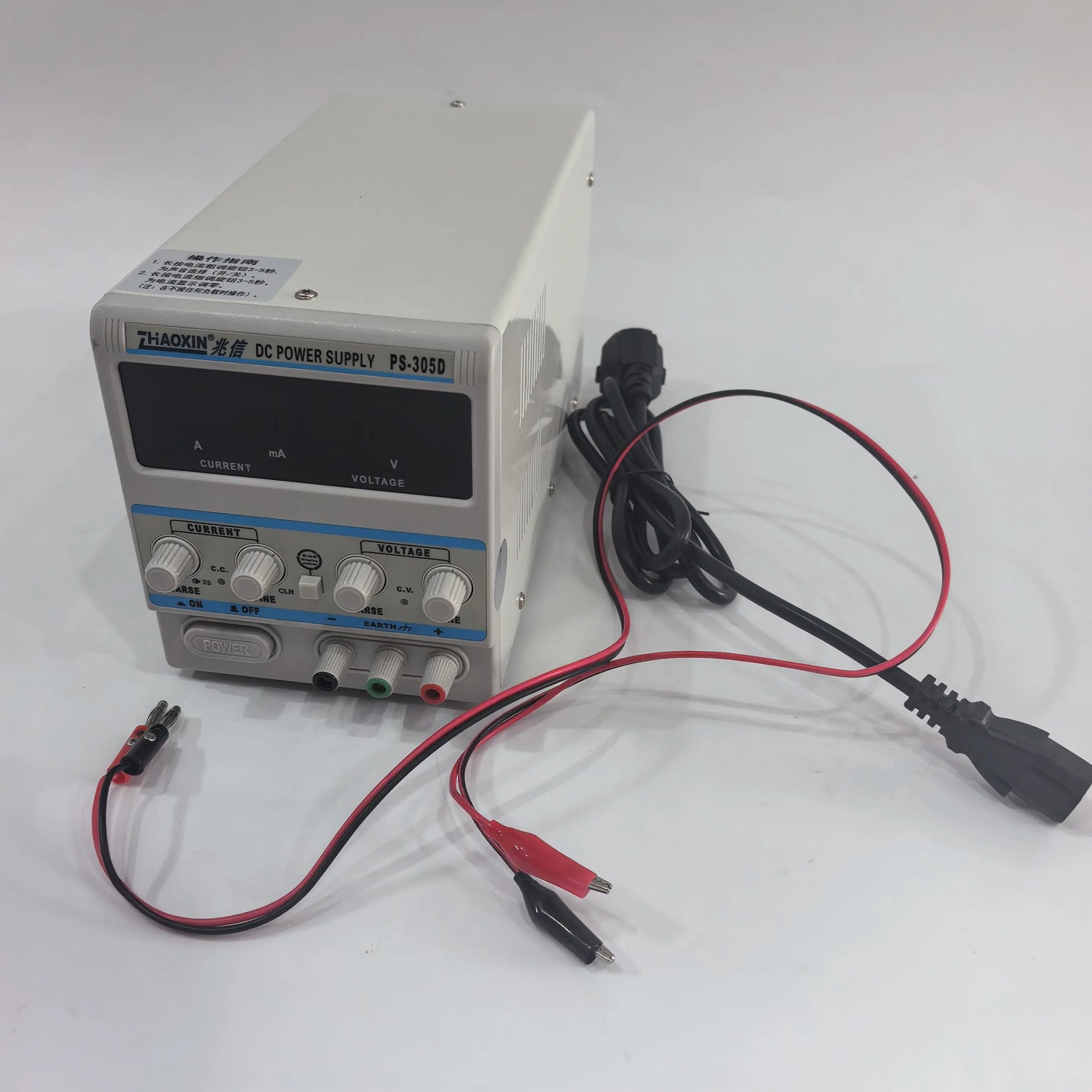 PS-305D bench power supply shown with power cord and test leads