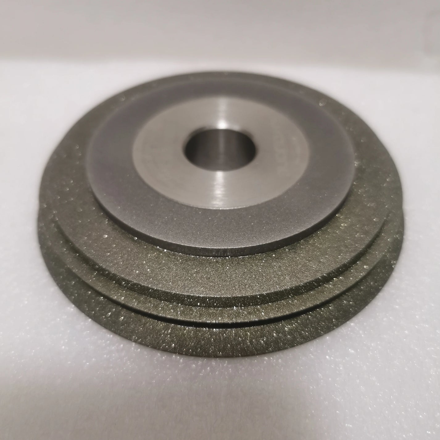 Cup-style E20HSDC180-600 grinding wheel profile with metal hub and abrasive outer ring