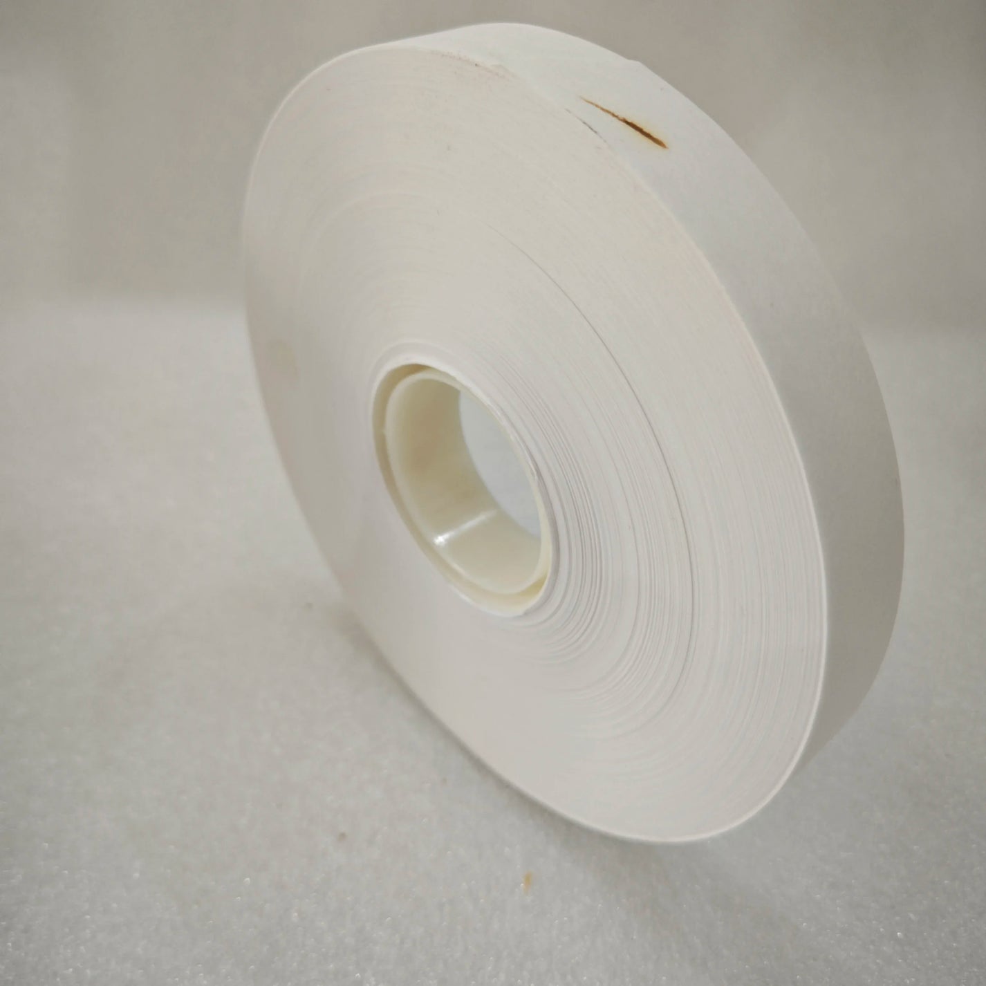 Side view of white 20mm paper banding tape roll for banknote bundling