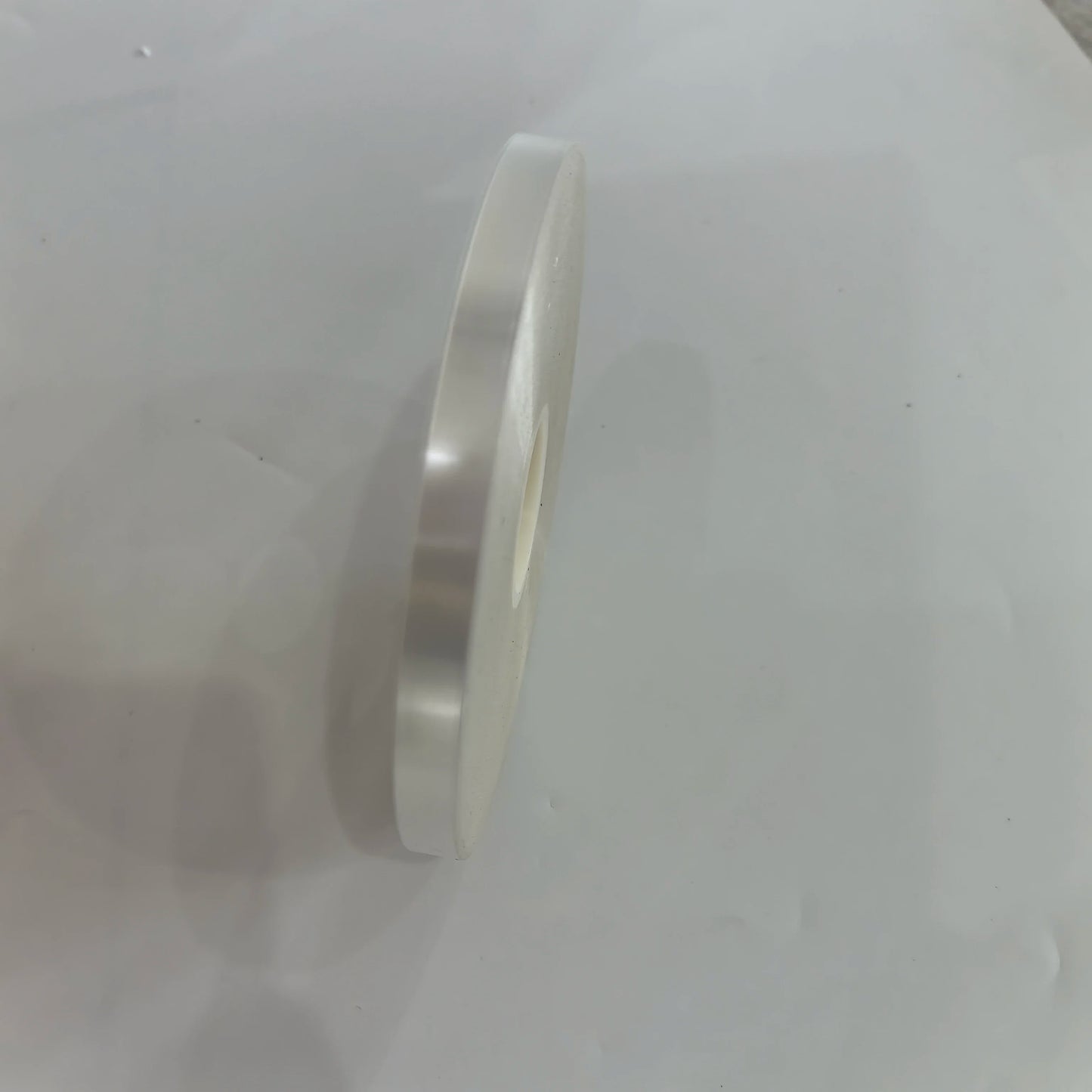 Side view of transparent OPP strapping tape roll for bundling machines