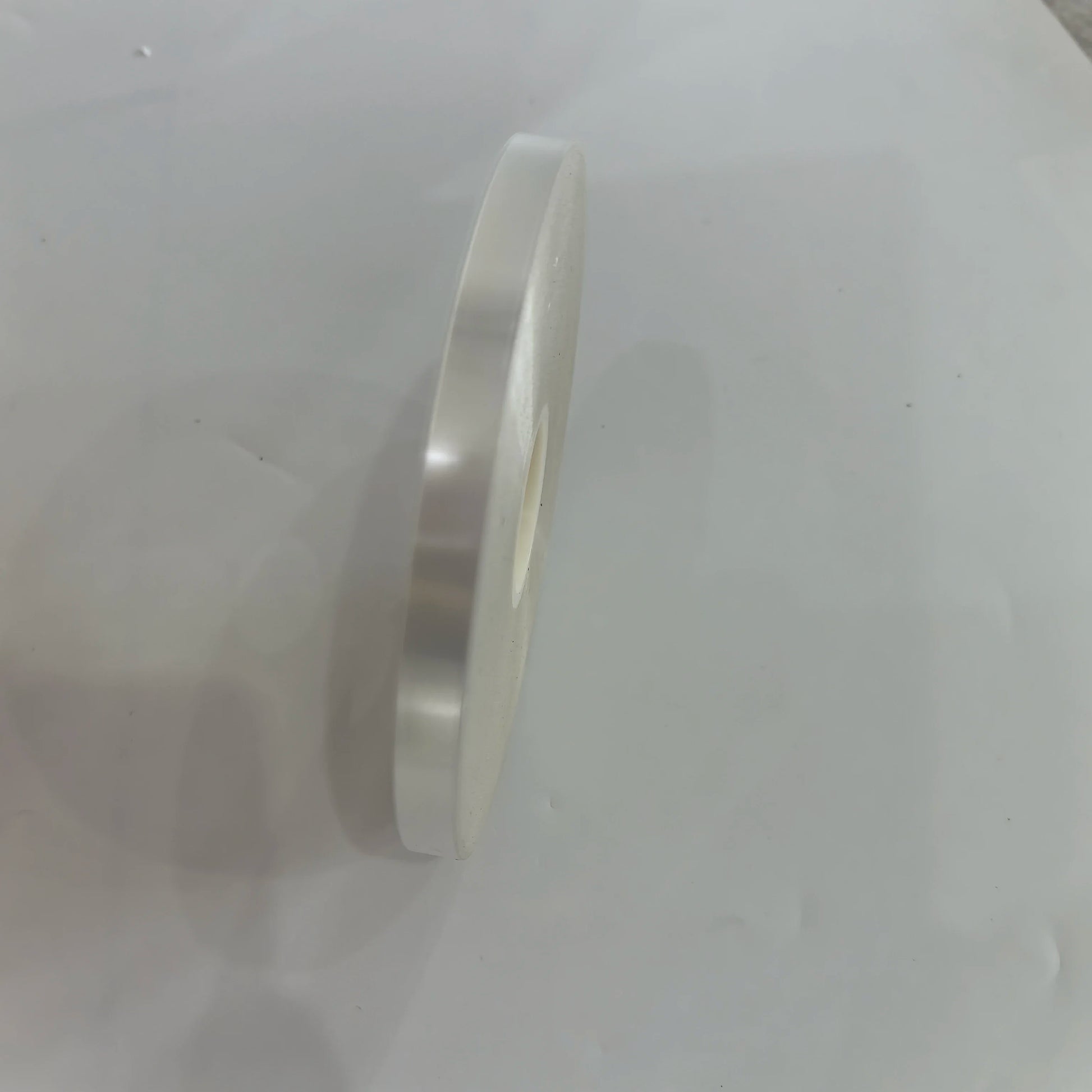 Side view of transparent OPP strapping tape roll for bundling machines