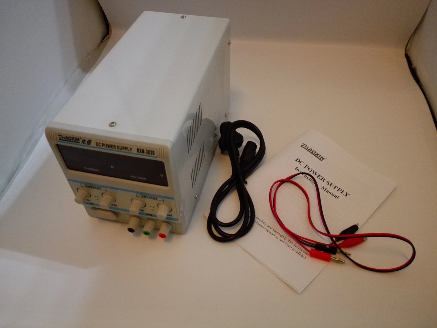 RXN-303D bench DC power supply with power cord test lead clips and user manual