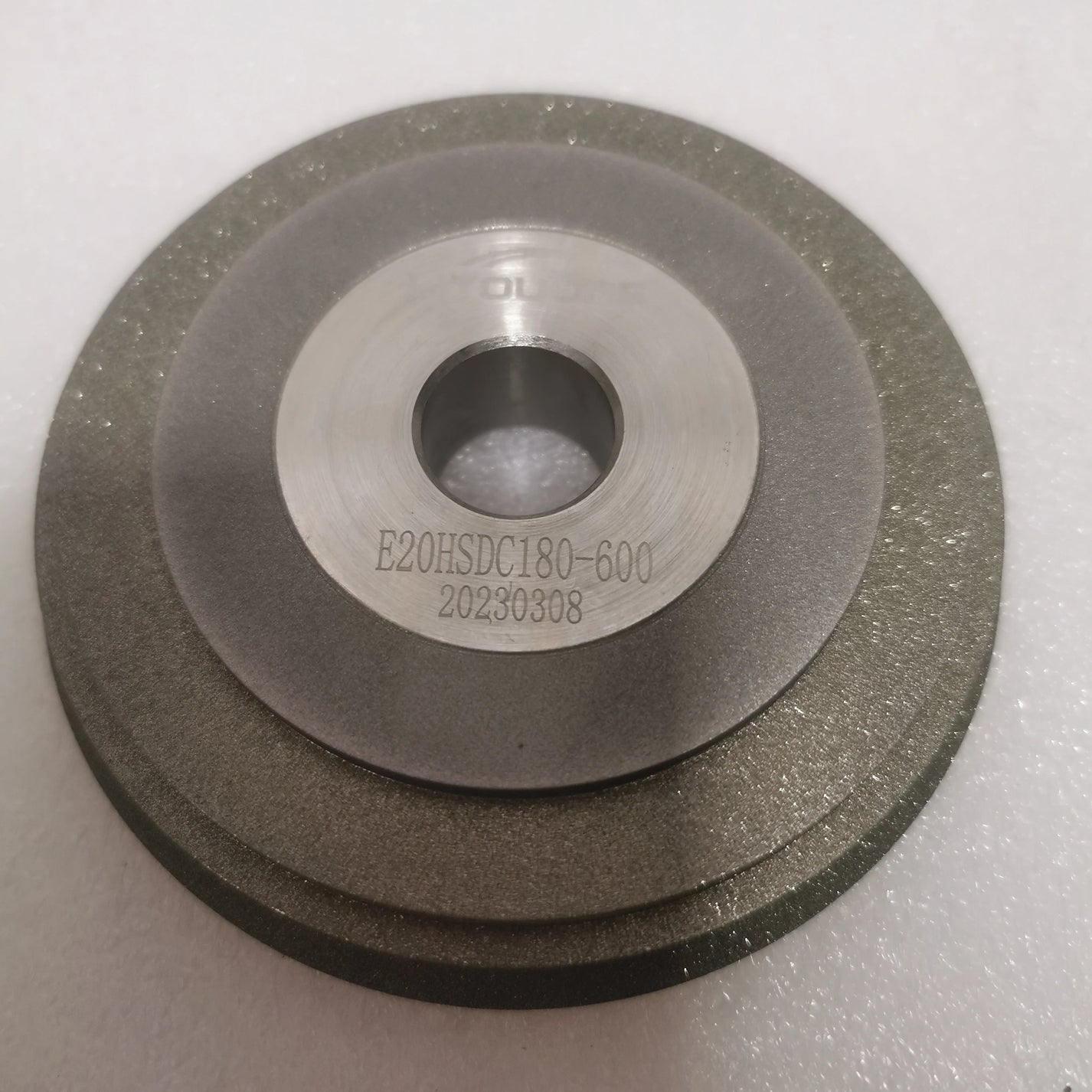 Close-up of E20HSDC180-600 model marking on SDC grinder machine wheel