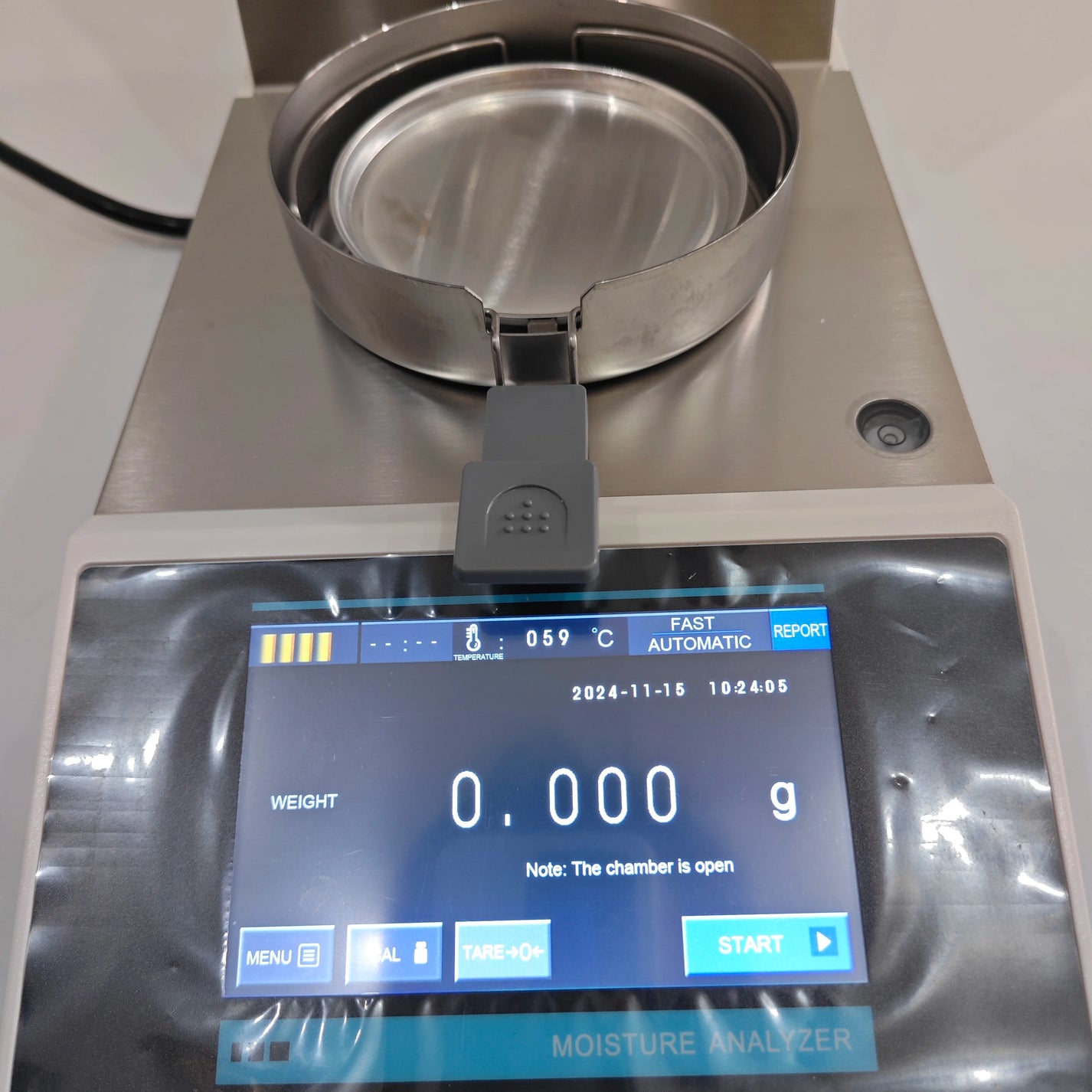 Benchtop moisture balance meter with sample pan and touchscreen controls