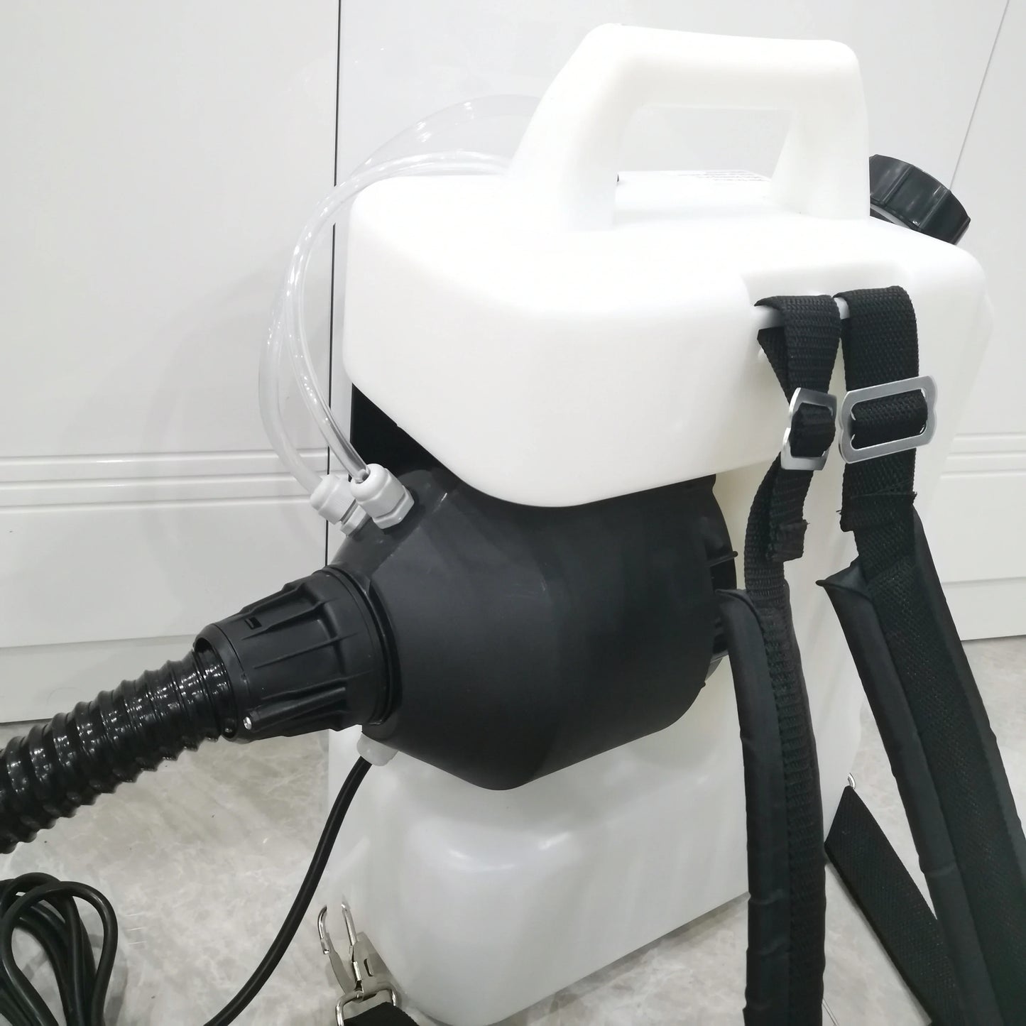 Close view of 10L backpack fogger tank, shoulder straps and hose connection