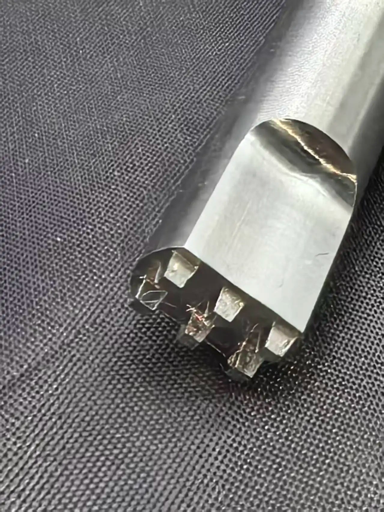 Ultrasonic welding horn tip positioned on non-woven fabric