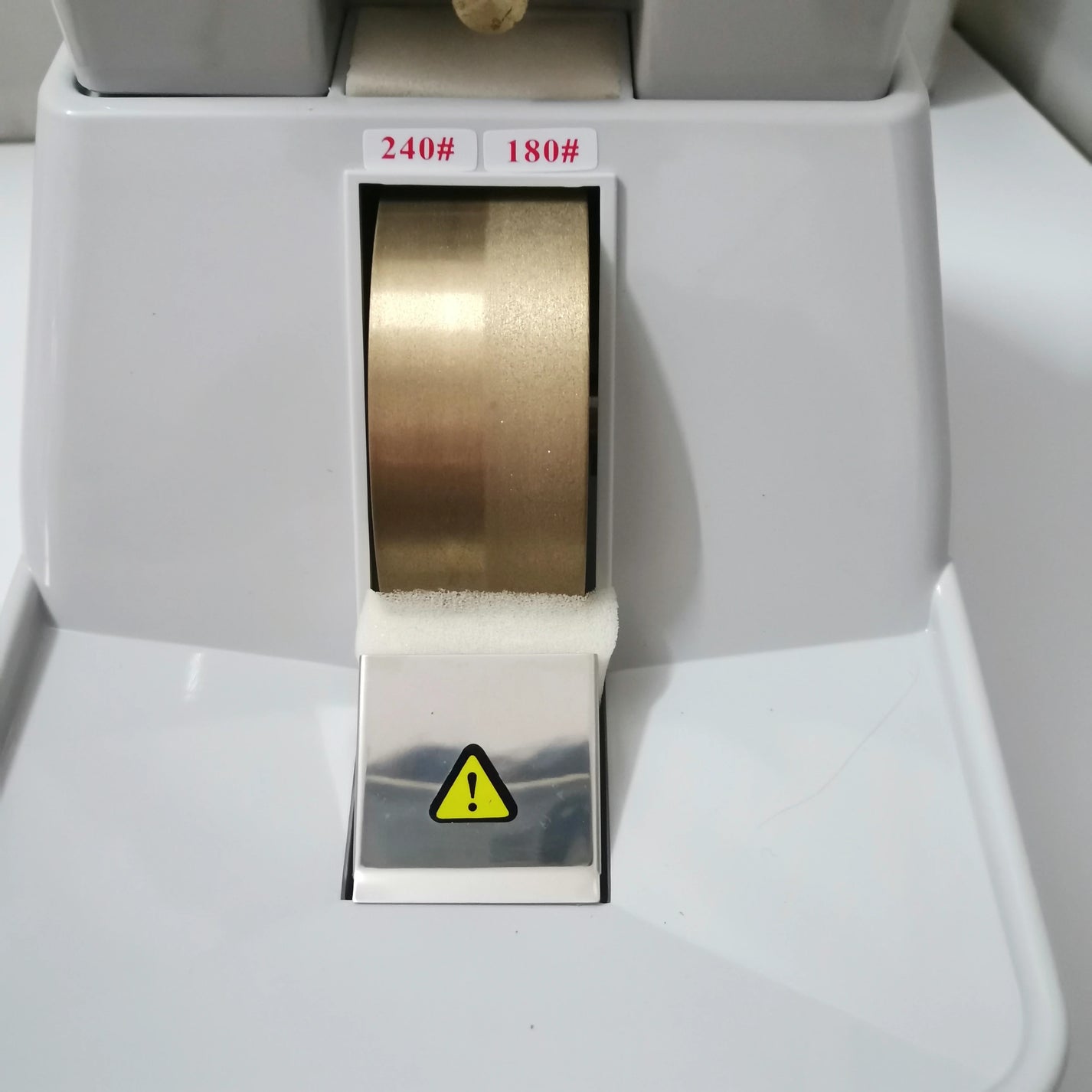 Close view of HLE-35WV lens grinder wheel area with 180 and 240 grit markings