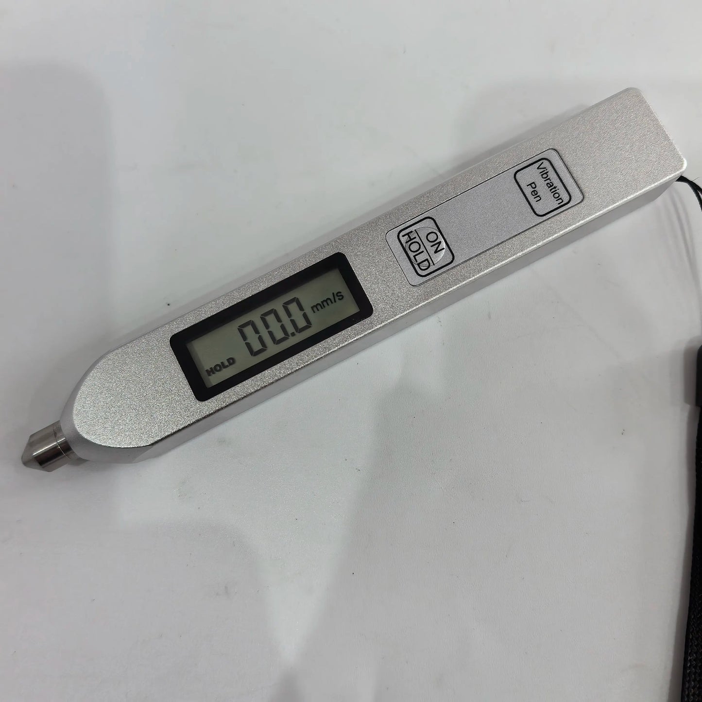 TV200 handheld vibration meter showing mm/s LCD and ON HOLD button