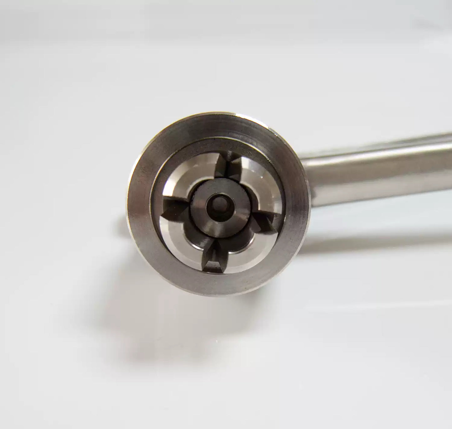 Close-up of four-segment vial cap crimping head